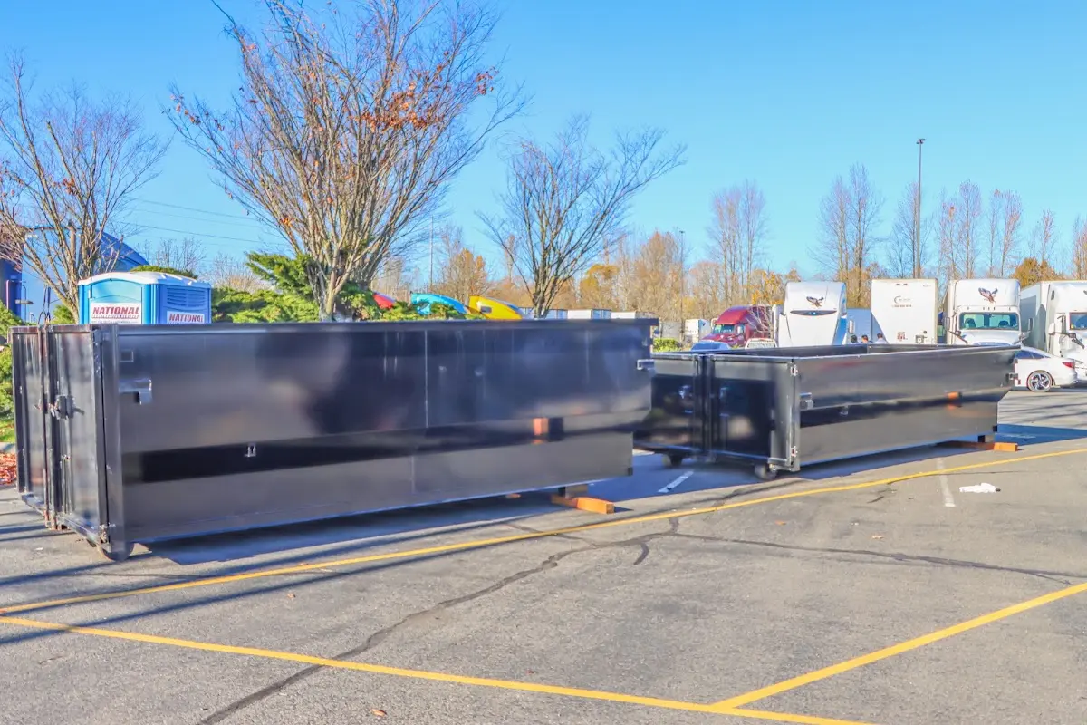 Professional dumpster rental service with roll-off container on residential driveway in California City